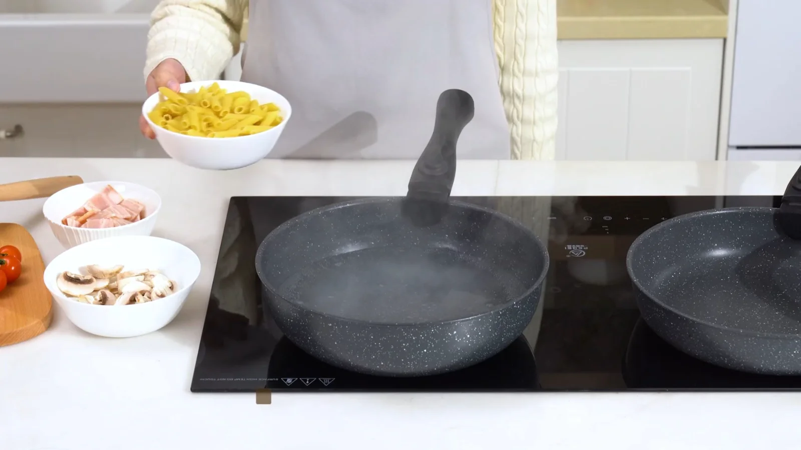 A SODAY detachable-handle pan frying potatoes on a compact induction hob